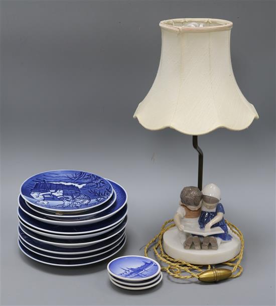 A collection of Royal Copenhagen plates and a lamp